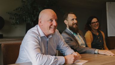 Jimmy Nilsson and two colleagues around a meeting table