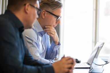 factor10 consultants looking at a screeen.